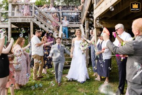 Two beautiful brides celebrating joyfully during a bubble exit at Naked Mountain Winery in Markham, VA, filled with excitement and happiness.